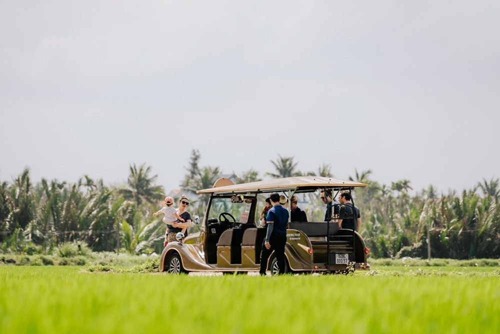 Tourists visit Bay Mau coconut village by electric car
